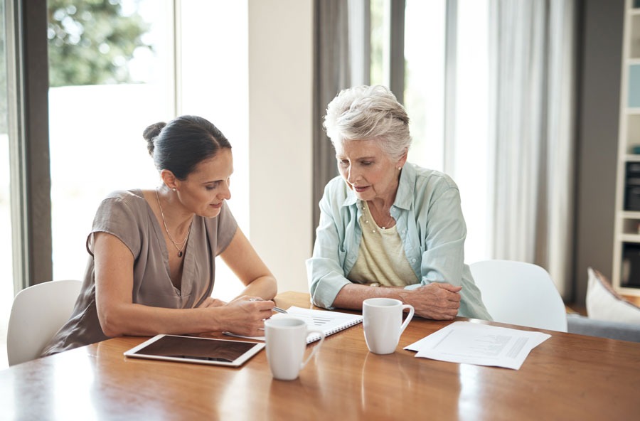 woman and elderly woman signing wills and trusts lawyers McAllen