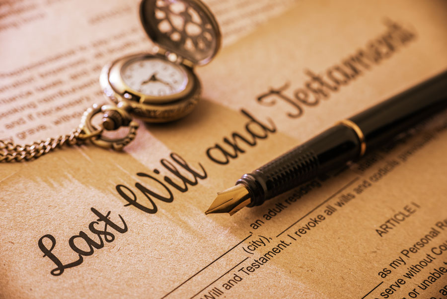 Fountain pen, pocket watch on a last will and testament from McAllen law firms.